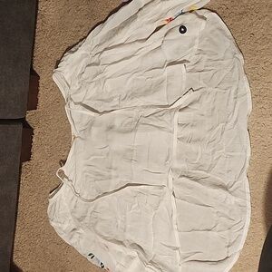 White blouse with flowers pattern on both sleeves size medium. Has tie on front.